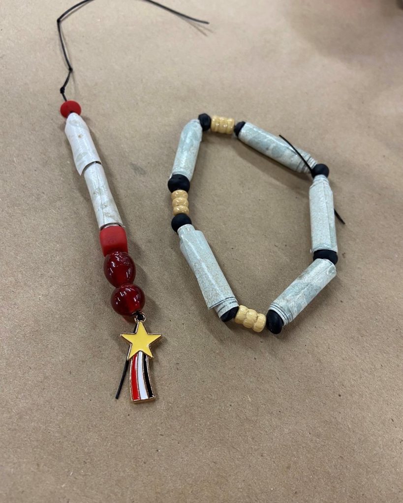 Paper bead bracelets created from participants' written stories at Camp Crossroads