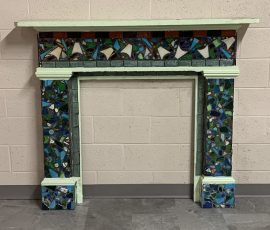 Brush With the Law art project community service volunteers helped design and add paint, glass, tiles to the table to give it a fresh, creative look Beautiful mosaic tile mantel frame, cool tones, decorative, upcycled